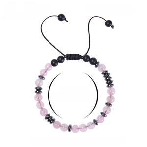 Morse code bracelet with pink crystal and black matte beads on white background