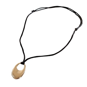 Minimalist gold oval hollow pendant necklace with black cord cord on a clean white background