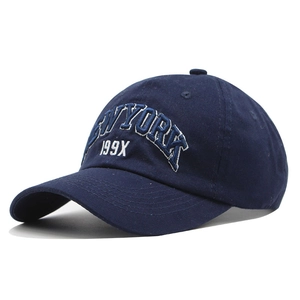 Detailed close-up of white 3D embroidery and cotton texture on navy baseball cap