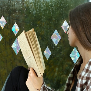 Rainbow prism diamond window film creating colorful holographic light on glass surface