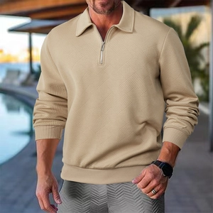 Detail of men's long-sleeve polo shirt featuring geometric embossed texture and half-zip