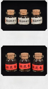 Macro shot of traditional handmade incense pearls in mini glass bottles with cork stoppers