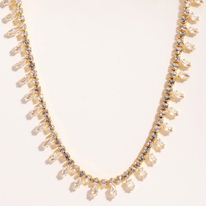 Elegant gold plated necklace featuring sparkling zircon teardrop fringe on white background