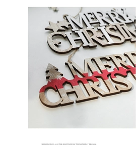 Macro view of a wooden Merry Christmas hanging ornament with red stripe detailing