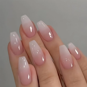 Close-up of pink and white gradient glossy coffin shape press-on nails on hands