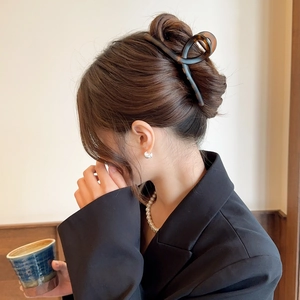 Elegant large amber acetate hair claw clip for women styled in a sophisticated updo