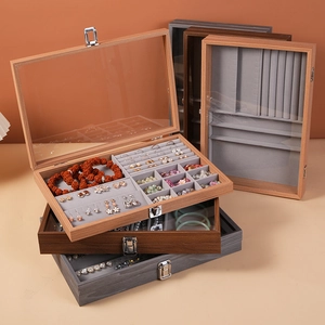 Walnut wood jewelry box with transparent glass lid and velvet lining for rings and earrings