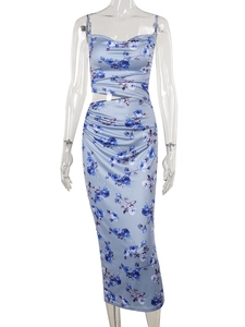 Detail of floral print maxi dress featuring waist cut-out and gathered ruched details