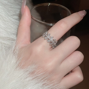 Close-up of sparkling zircon snowflake rotating ring on finger with luxury silver finish