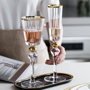 Luxury gold-rimmed ribbed crystal glass set with a wine goblet and champagne flute