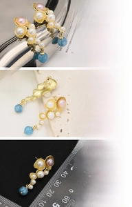 Detailed view of 18K gold plated earrings with freshwater pearls and blue gemstones