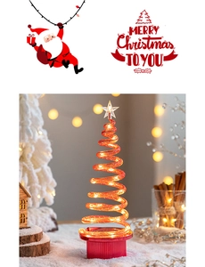 Macro detail of spiral LED Christmas tree with star topper on warm festive background