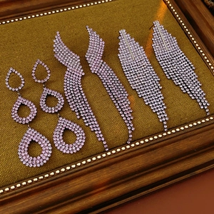 Detail of lavender crystal tassel earrings in three styles on a vintage frame background