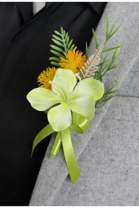 Detail of a green lily boutonniere with yellow accents on a gray wool suit lapel