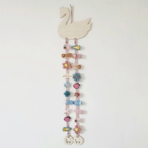 Wooden swan hair clip holder organizer with pink ribbons and colorful accessories