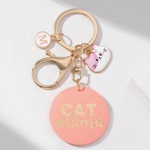 Porte-clés CAT MAMA doré avec breloque rose, visage de chat et pendentif lettre M
