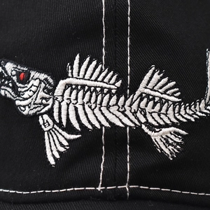 Cotton baseball cap featuring white fish bone embroidery and red eye detail stitching