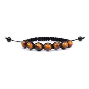 Handmade woven bracelet featuring natural tiger eye beads with adjustable black cord