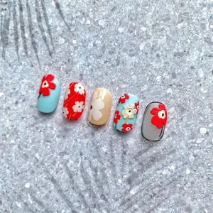 Macro view of blue and red floral nail art stickers with French summer pattern designs
