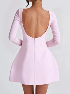 Detailed back view of pink long sleeve mini dress featuring an elegant open back design