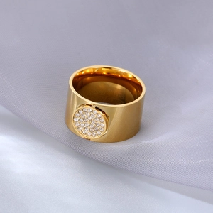 Chic gold-plated wide band ring featuring a sparkling zircon pave center on silk background