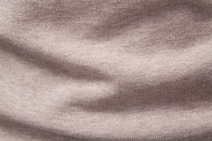 Close-up of high-quality pink knitted fabric texture showing soft warm sweater material
