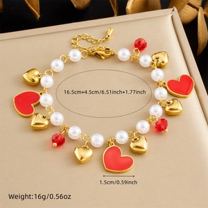 Elegant stainless steel pearl bracelet with red heart pendants on a gold gift box