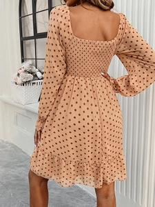 Detailed back view of a brown polka dot maxi dress featuring smocked elastic texture