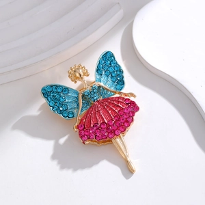 Detailed close-up of butterfly girl brooch with blue wings and pink rhinestone dress