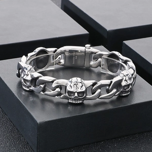 Detail of 316L stainless steel skull cuban chain bracelet on a black gift box
