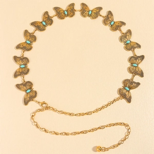 Vintage metal butterfly waist chain with turquoise accents for dresses shown on flat surface