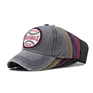 Detail showing various colors of washed cotton baseball caps with team embroidery
