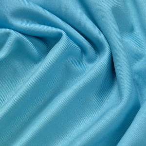 Macro detail of sky blue ribbed knit fabric showing fine textured vertical stripes