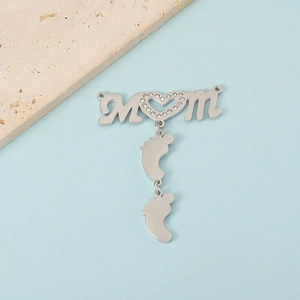 Detailed view of silver MOM charm with rhinestone heart and baby feet pendants