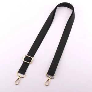 Adjustable black nylon shoulder strap for crossbody bags with gold metal swivel hooks