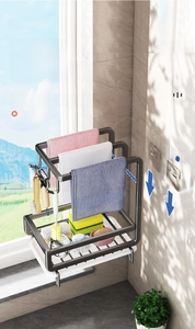Detail of grey wall-mounted sponge rack with towel bars and drainage tray for kitchen sink