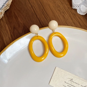 French oil painting style yellow resin oval earrings with beige beads on lace background