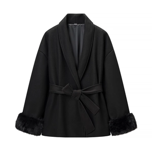 Detail of women's black wool coat showing plush faux fur cuffs and waist tie belt