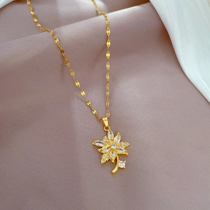 Detail of gold titanium flower petal pendant set with sparkling zircon on silk