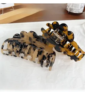 Detail of tortoise shell acetate claw clips with wavy edges and durable metal springs
