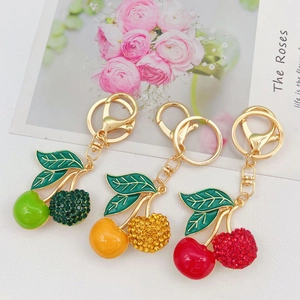 Three creative cherry keychains with rhinestones and enamel in red yellow and green