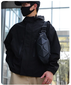 Side view of black hardshell sling bag with geometric texture for tactical urban outfits