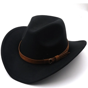Detail of black cowboy hat with brown leather band, metal buckle and stylish tassels
