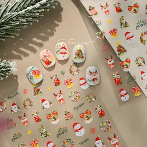 Detail view of festive Christmas nail stickers with Santa and reindeer motifs