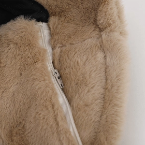 Detailed macro view of high-quality zipper on thick brown faux fur winter hat