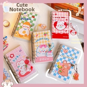 Detailed view of cute PVC 6-hole binder journals with cartoon bear and rabbit illustrations