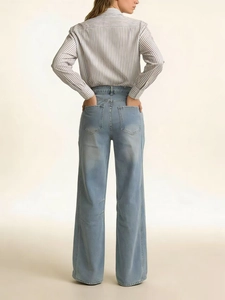 Rear view of vintage high waist wide leg jeans paired with a striped long sleeve shirt