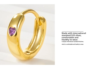 Detail view of 925 silver heart earring with purple crystal and gold finish