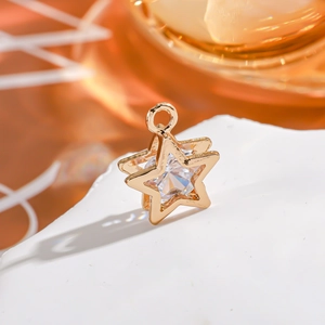 Detailed macro shot of a gold 14K star pendant featuring a brilliant cut zircon stone