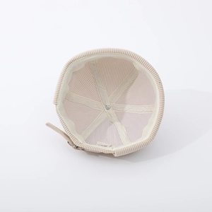 Detail view of the soft inner lining and adjustable back buckle of the beige baby beanie